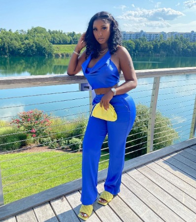 Bernice Burgos is wearing blue dress and posing for a photo.